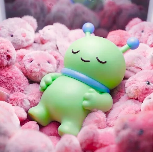 Alien avatar sleeping on a plush toy